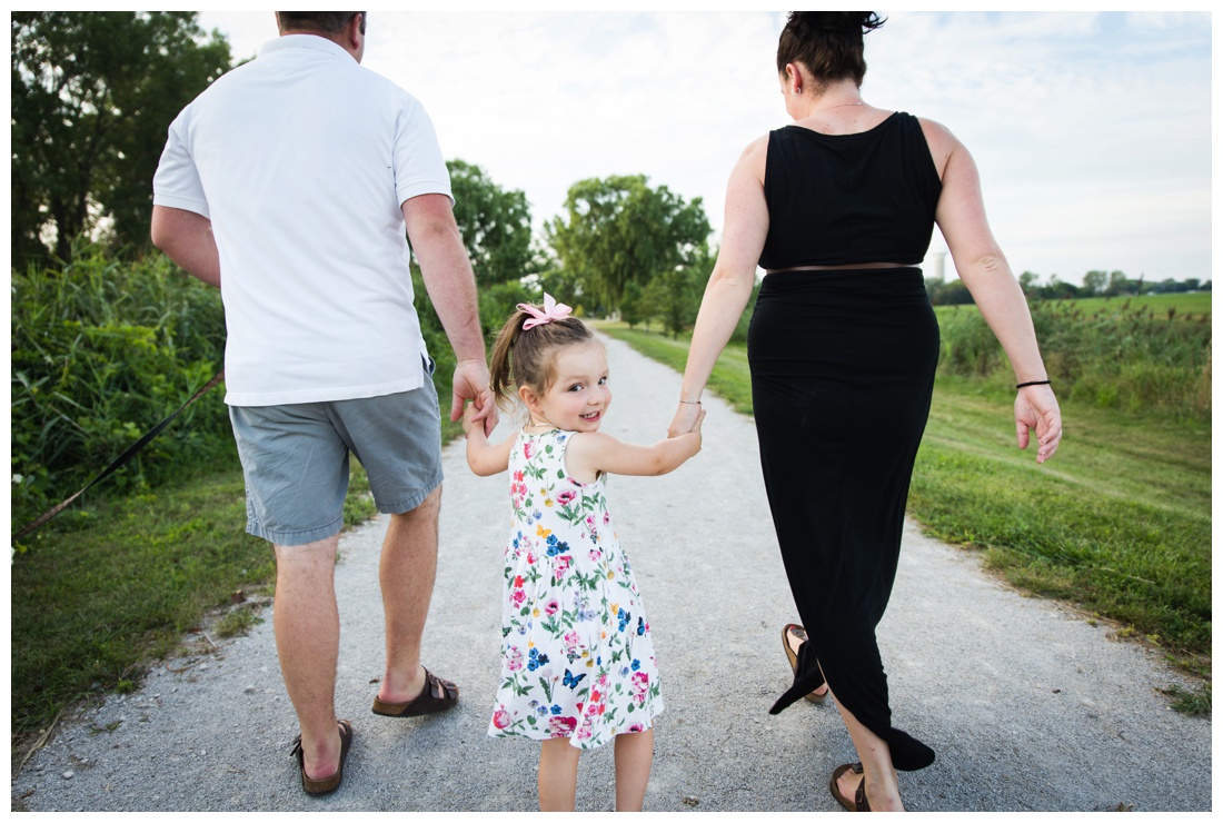 brittany vanruymbeke, chatham-kent family photographer, chatham-kent maternity photography, sarnia maternity photographer, family maternity, toddler girl walking between parents looking back