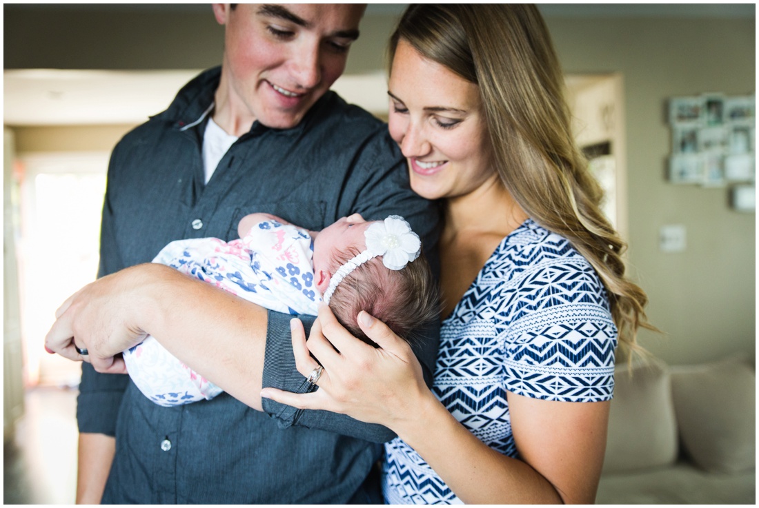 Chatham ON Lifestyle Newborn Photographer, Brittany VanRuymbeke Photos + Films, new parents holding newborn daughter smiling