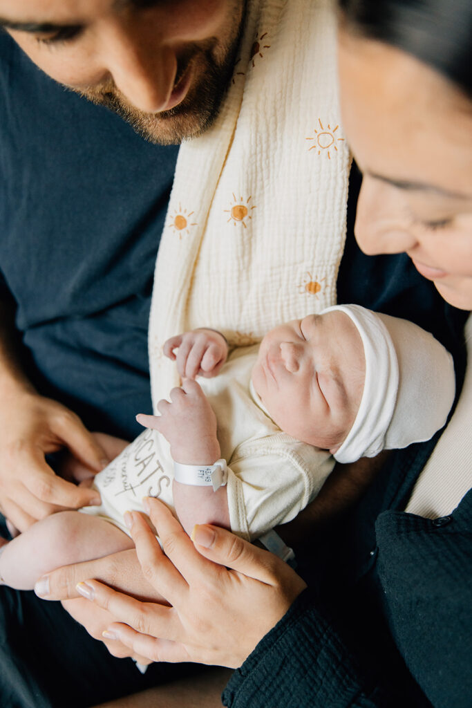 "Parent holding newborn skin-to-skin, Fresh 48 in-hospital session, Sarnia-Lambton Ontario photographer Brittany VanRuymbeke"