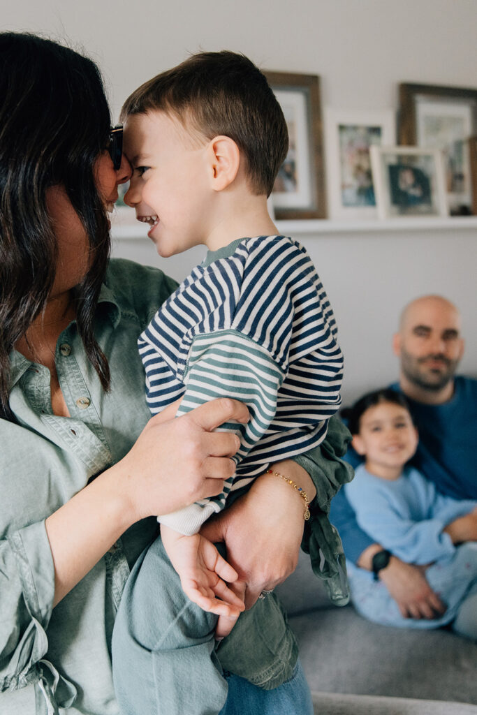 Family photo session in bold greens and blues, styled against a neutral-toned living room in Chatham-Kent.