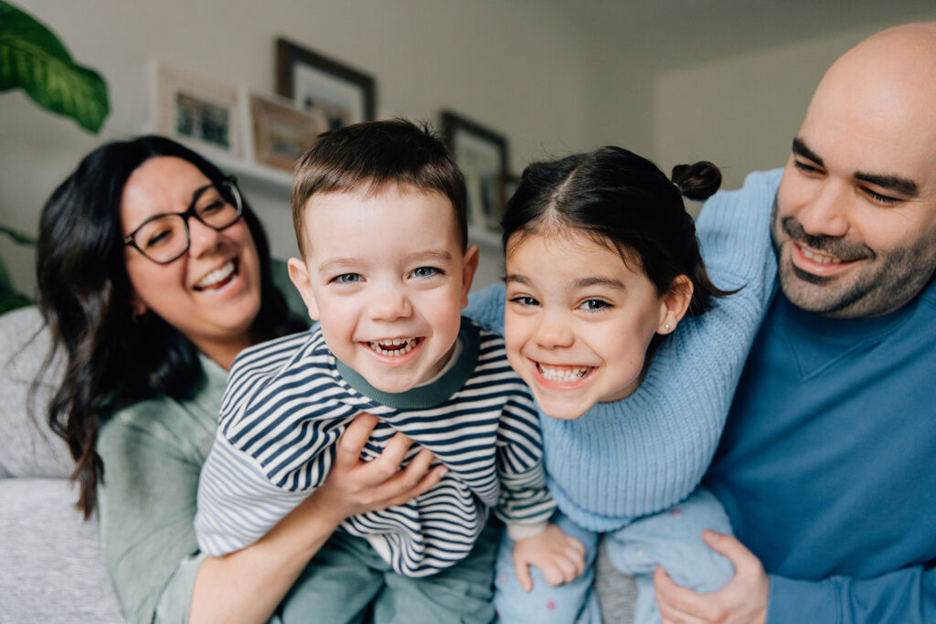 Family photo session in bold greens and blues, styled against a neutral-toned living room in Chatham-Kent
