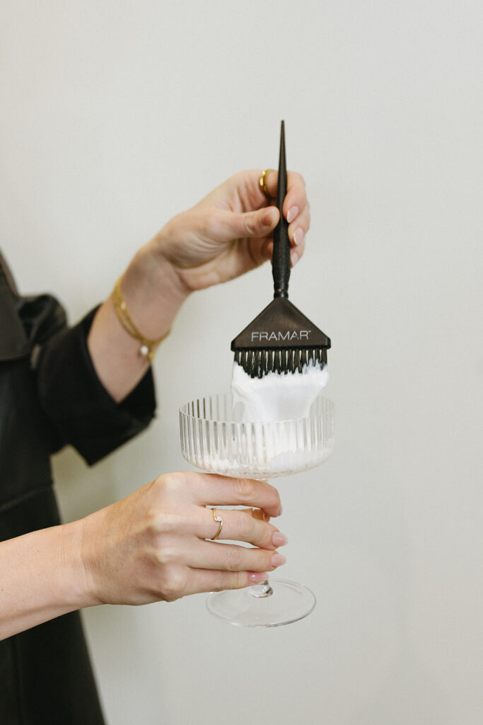 Close-up of hands holding styling salon supplies, faceless brand content