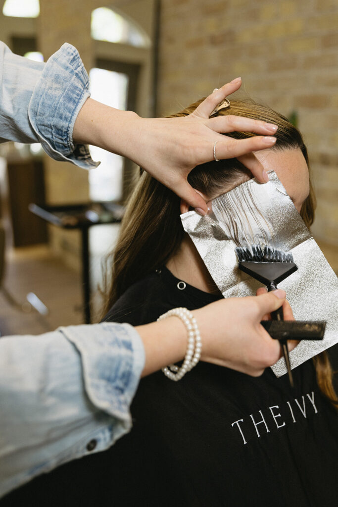 Close up of hands styling hair during Sarnia brand photography session