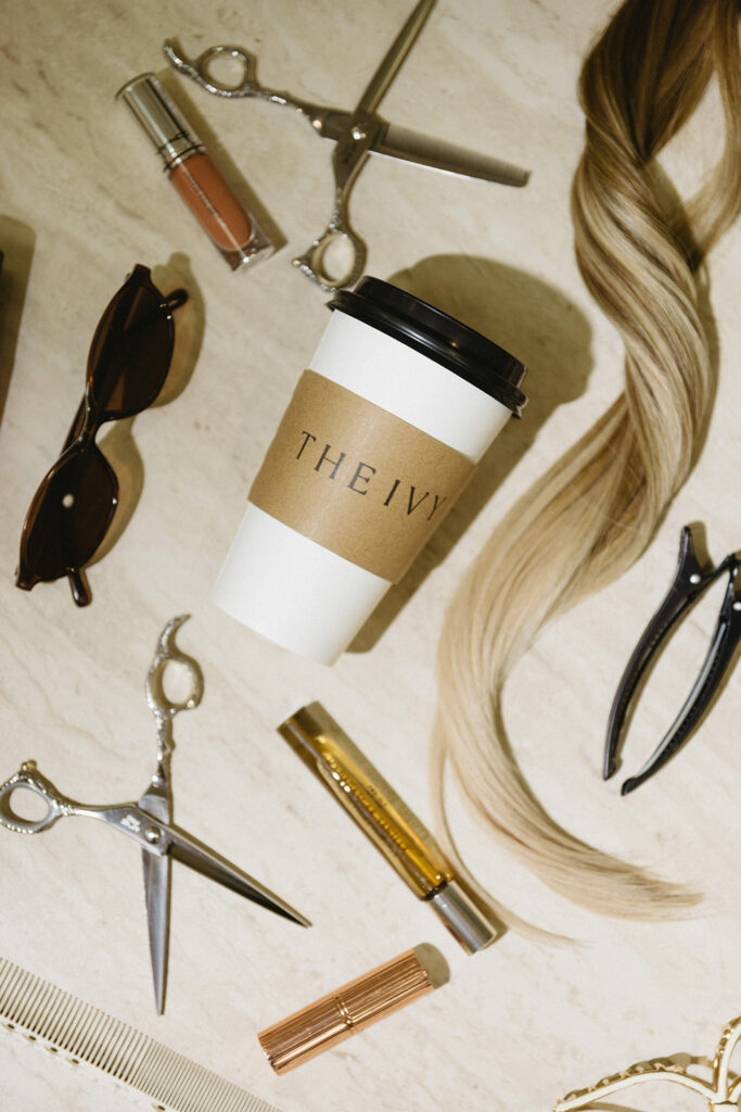 Flat lay of hair salon tools and products styled for brand photography