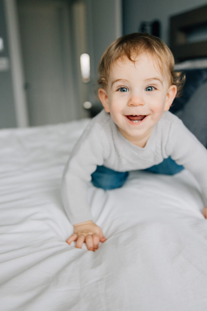 Mom and dad playing with toddler during in home family session in chatham ontario