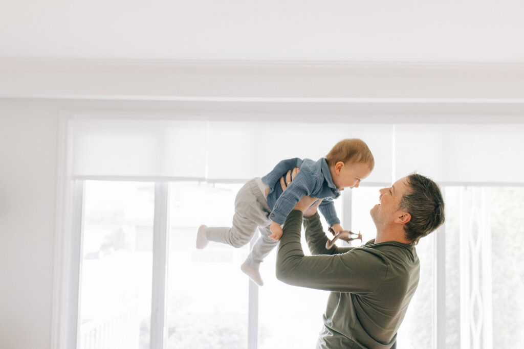 Dad playing with toddler during in home family session in sarnia